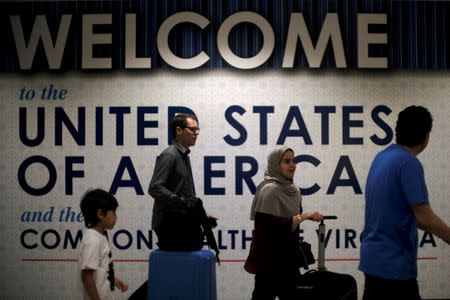 International passengers arrive at Washington Dulles International Airport after the U.S. Supreme Court granted parts of the Trump administration's emergency request to put its travel ban into effect later in the week pending further judicial review, in Dulles, Virginia. REUTERS/James Lawler Duggan