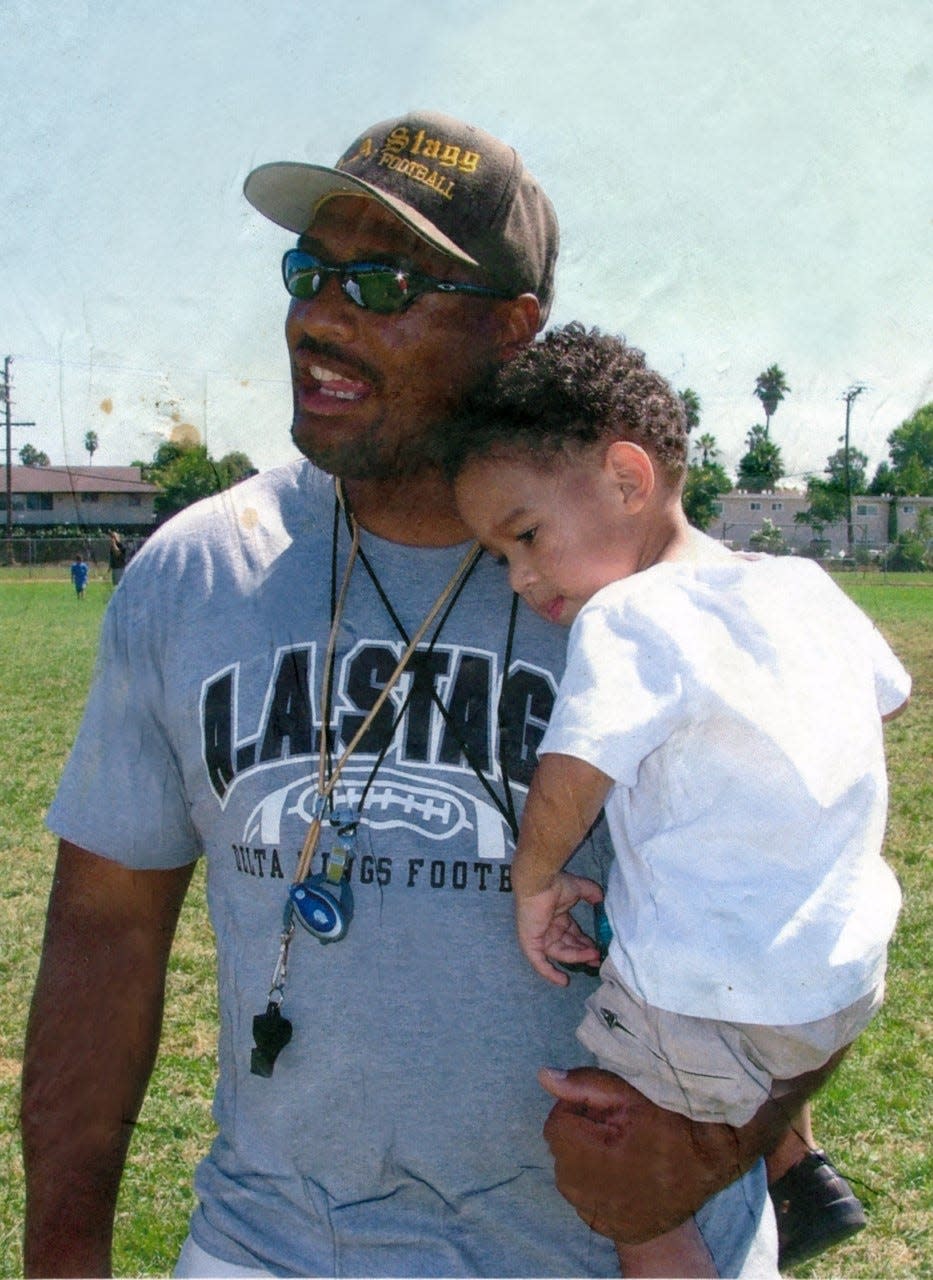Eric Hankins Sr. holds a Eric Hankins II when he was younger during one of Stagg football practices in the early 2000s.