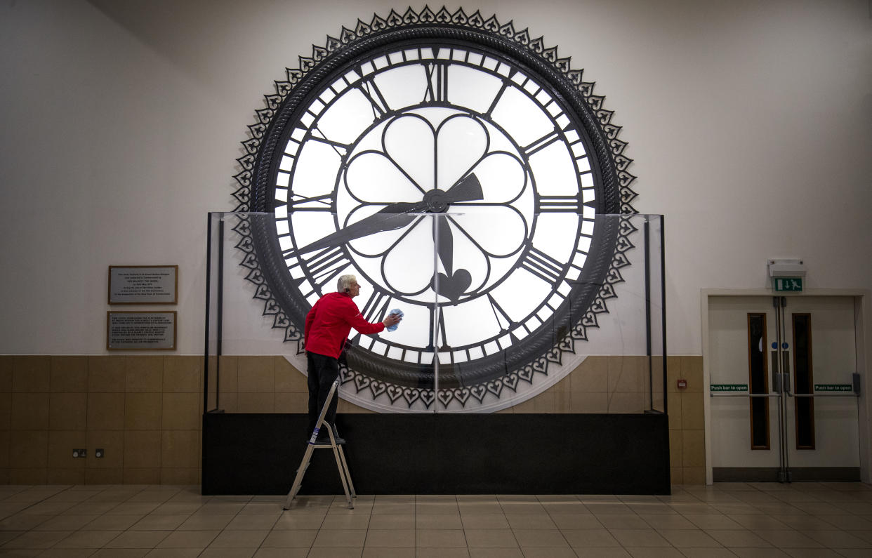 Dougie Cook, from the housekeeping team, cleans the St Enoch Clock in the Antonine Centre in Cumbernauld. The historic clock originally hung from the roof of the old St Enoch railway station in Glasgow and was made famous when it featured prominently in the 1981 film 'Gregory's Girl'. (Photo by Jane Barlow/PA Images via Getty Images)