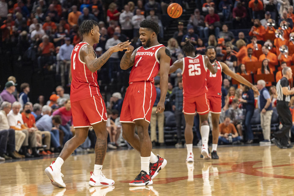 Houston guards Marcus Sasser (0) and Jamal Shead (1) celebrate during the second half of an NCAA college basketball game against Virginia in Charlottesville, Va., Saturday, Dec. 17, 2022. (AP Photo/Erin Edgerton)