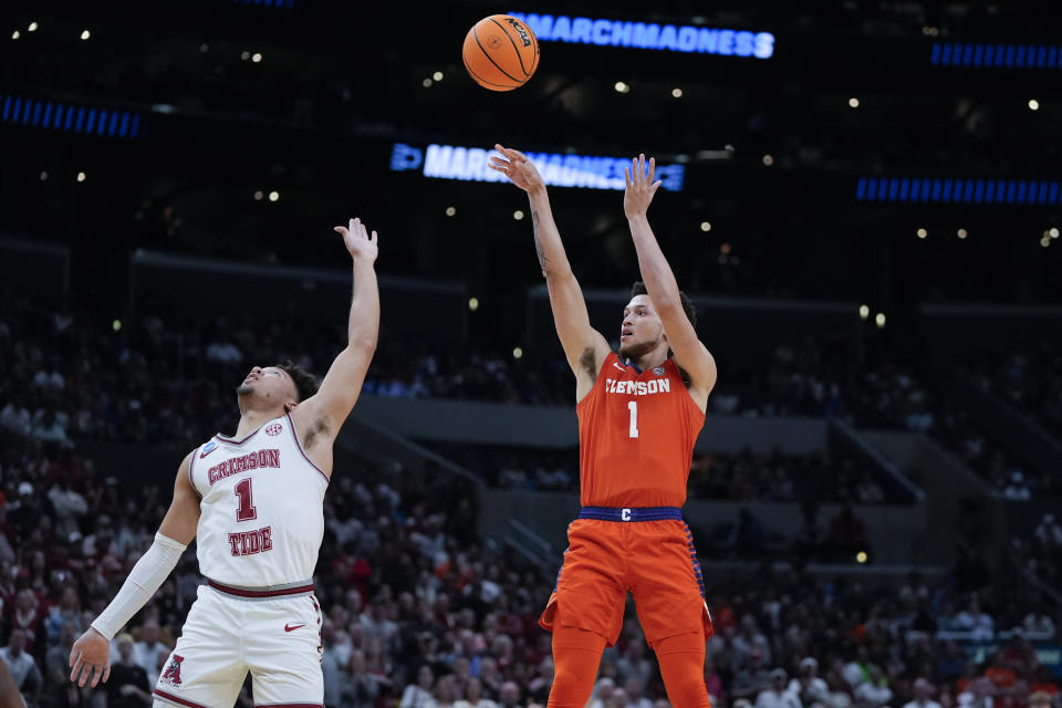 Clemson guard Chase Hunter, right, shoots over Alabama guard Mark Sears (1) during the second half of an Elite 8 college basketball game in the NCAA tournament Saturday, March 30, 2024, in Los Angeles. (AP Photo/Ryan Sun)