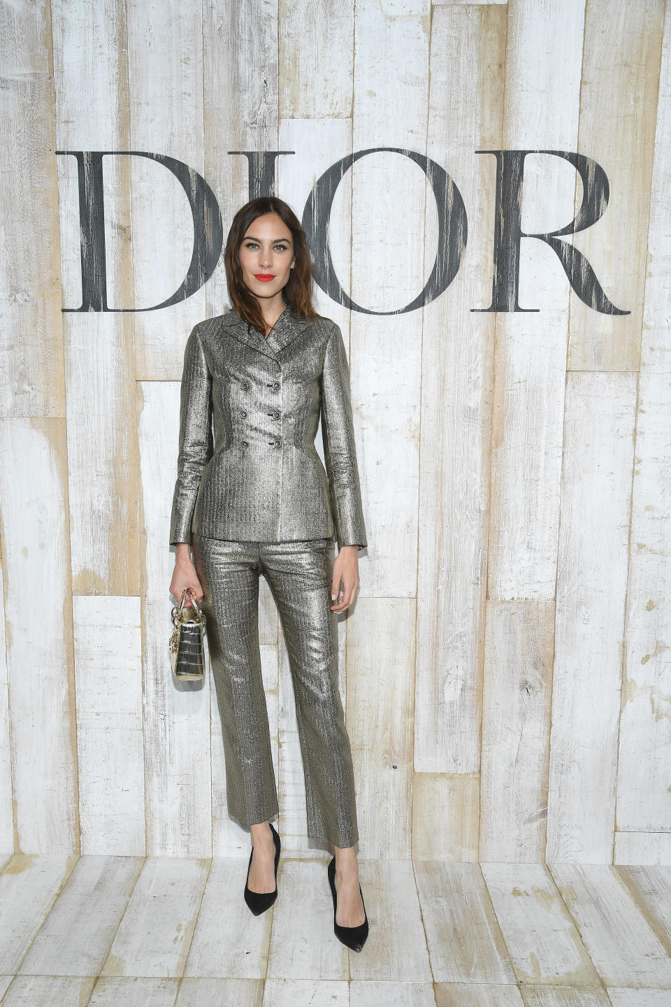 <p>The model showed off her sartorial prowess in a metallic trouser suit paired with a bright lip. <em>[Photo: Getty]</em> </p>