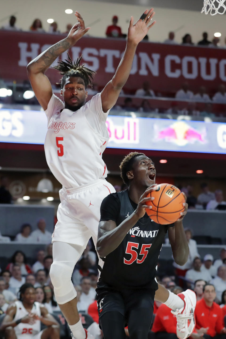 Cincinnati forward Aziz Bandaogo (55) looks to shoot as Houston forward Ja'Vier Francis (5) jumps behind during the first half of an NCAA college basketball game Tuesday, Feb. 27, 2024, in Houston. (AP Photo/Michael Wyke)