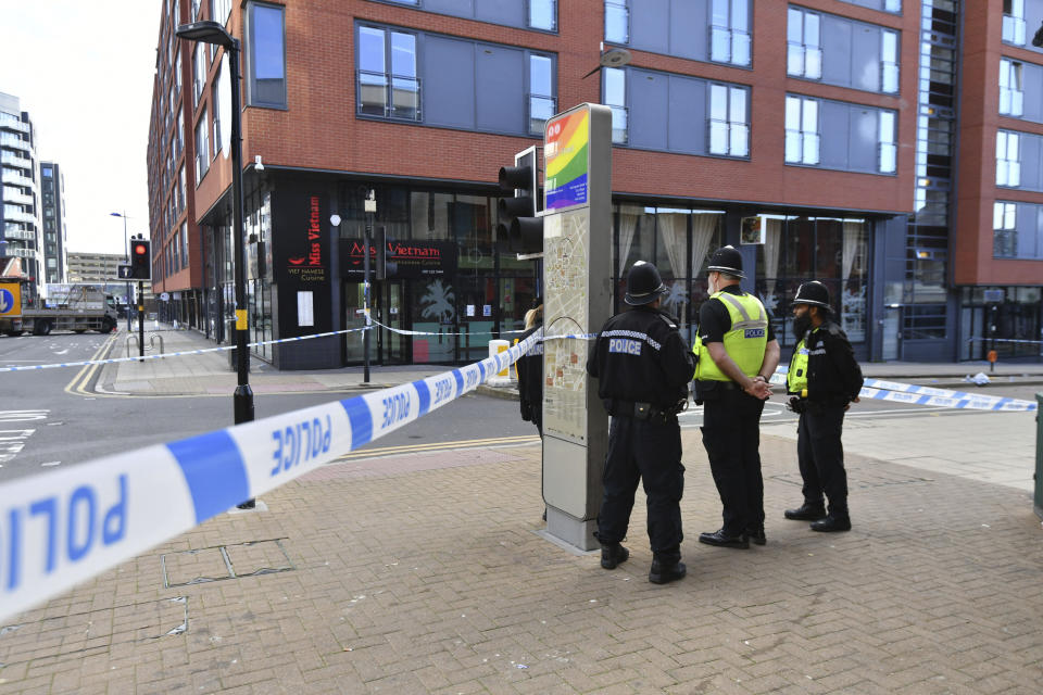 Police officers stand at a cordon in Hurst Street in Birmingham after a number of people were stabbed in the city centre on Sunday. Source: AP