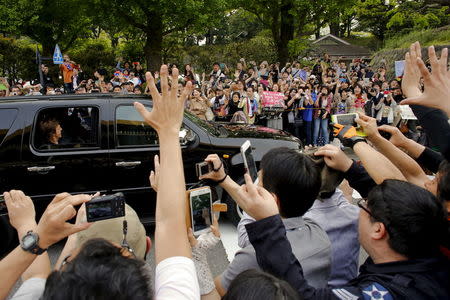 Fans wave and take pictures as Paul McCartney arrives for his gig at the Nippon Budokan Hall in Tokyo April 28, 2015. REUTERS/Thomas Peter