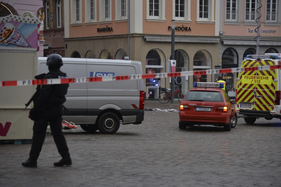 A square is blocked by the police in Trier, Germany, Tuesday, Dec. 1, 2020. German police say two people have been killed and several others injured in the southwestern German city of Trier when a car drove into a pedestrian zone. Trier police tweeted that the driver had been arrested and the vehicle impounded. (Harald Tittel/dpa via AP)