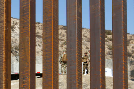 U.S. Army soldiers stand along the fence between San Ysidro, California and Tijuana, Mexico November 9, 2018. REUTERS/Jorge Duenes