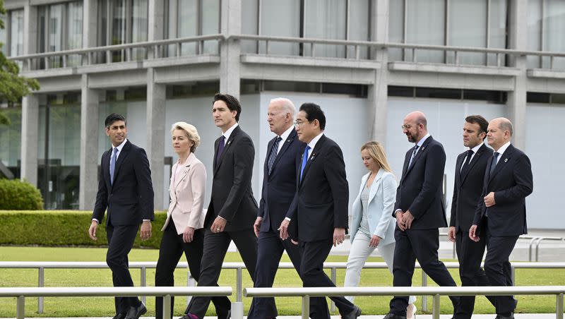 From left, British Prime Minister Rishi Sunak, European Commission President Ursula von der Leyen, Canadian Prime Minister Justin Trudeau, U.S. President Joe Biden, Japan’s Prime Minister Fumio Kishida, Italian Premier Giorgia Meloni, European Council President Charles Michel, French President Emmanuel Macron and German Chancellor Olaf Scholz walk to get into place to participate in a wreath laying ceremony at the Peace Memorial Park as part of the G7 Hiroshima Summit in Hiroshima, western Japan Friday, May 19, 2023.