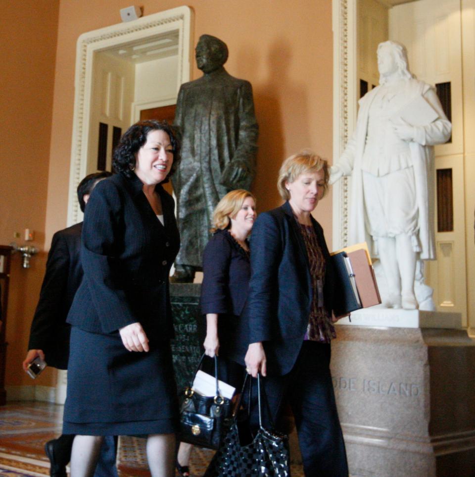 In this photo from June 2, 2009, then-Supreme Court nominee Sonia Sotomayor walks through the Capitol to a meeting with Senate Minority Leader Mitch McConnell of Ky., on Capitol Hill in Washington. She is accompanied by Cynthia Hogan, right, Vice President Biden's counsel, and White House adviser Stephanie Cutter, center.