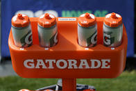 Hydration bottles with individual player numbers on them are organized by position on a rack at Seattle Seahawks NFL football training camp, Wednesday, Aug. 12, 2020, in Renton, Wash. Individual bottles for water and sports drinks are one of many measures taken by the team due to the coronavirus. (AP Photo/Ted S. Warren, Pool)