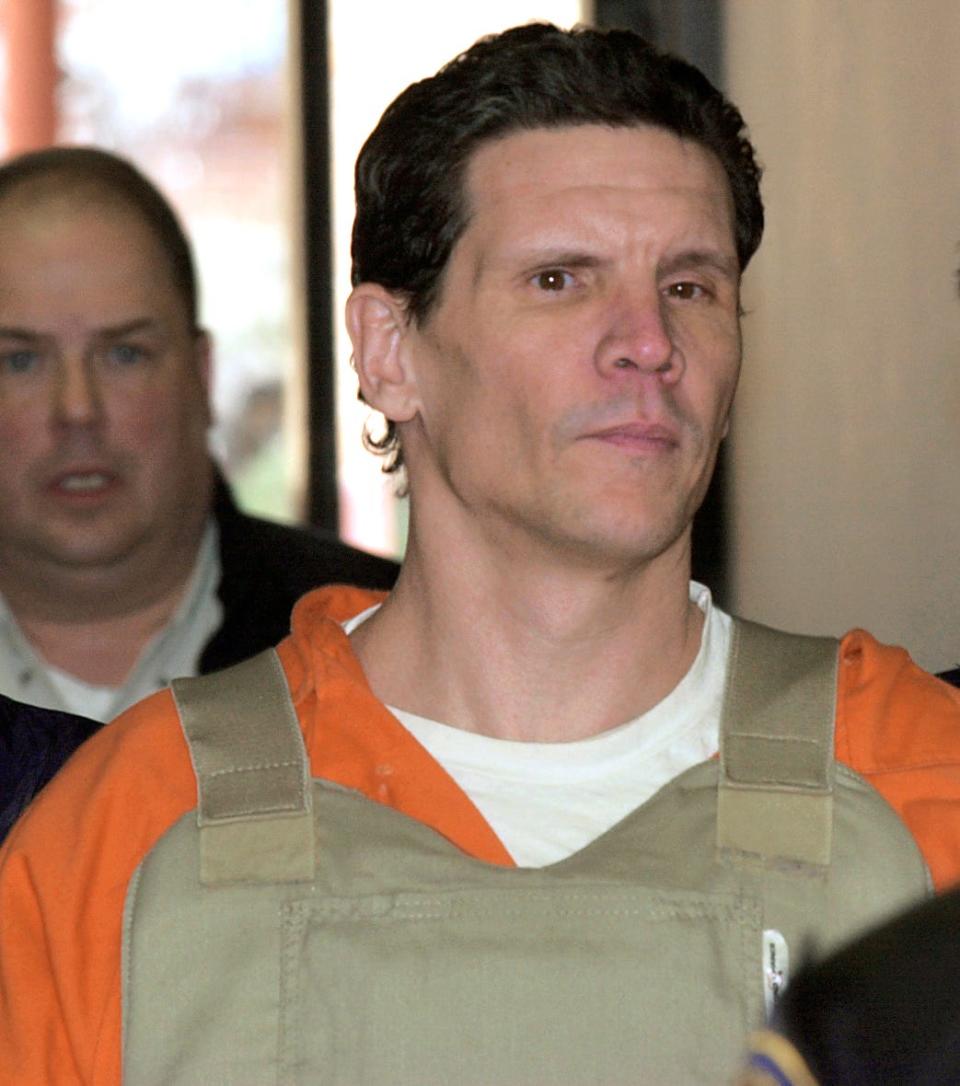 Scott Eizember is escorted into a Bristow courtroom for a hearing in 2004.