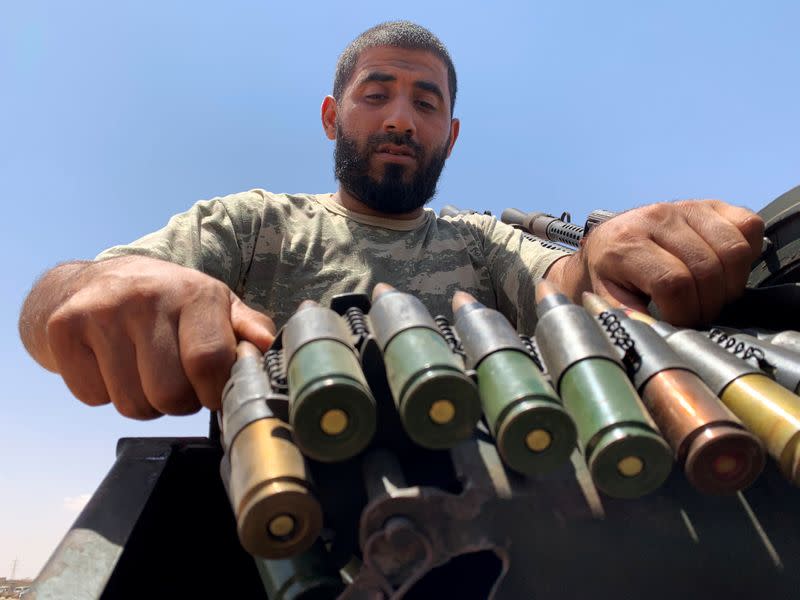 A member of the troops loyal to Libya's internationally recognized government prepares before heading to Sirte, on the outskirts of Misrata