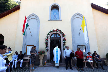 A bishop enters the main chapel as Roma families wait outside in Csatka, Hungary on September 9, 2017. REUTERS/Laszlo Balogh