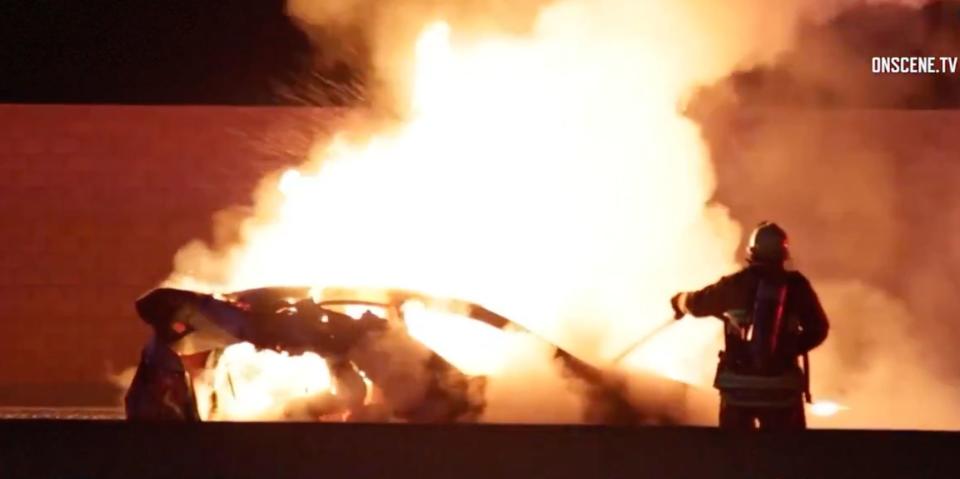 A vehicle carrying a family of three on a Los Angeles freeway caught on fire after a collision with an off-duty officer's vehicle, authorities said. (Photo: OnsceneTV)