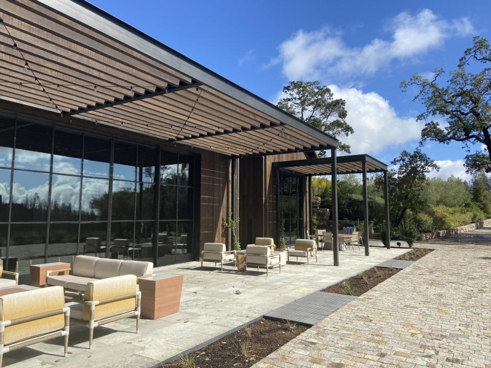Outside the newly rebuilt — and more modern — tasting room at Mayacamas Vineyards. The original tasting room, which also served as a residency for previous owners, burned down during the 2017 California wildfires. “We wanted to keep the new hospitality space in the same spot as the old house, on the hillside,” said Kris Kraner, Mayacamas’ estate director. “We did make it a little bit more modern. But we wanted to make it feel cohesive with the winery as well. So hopefully when you walk up, it feels like it’s a place that’s been here for over a century.” - Credit: Kellie Ell / WWD
