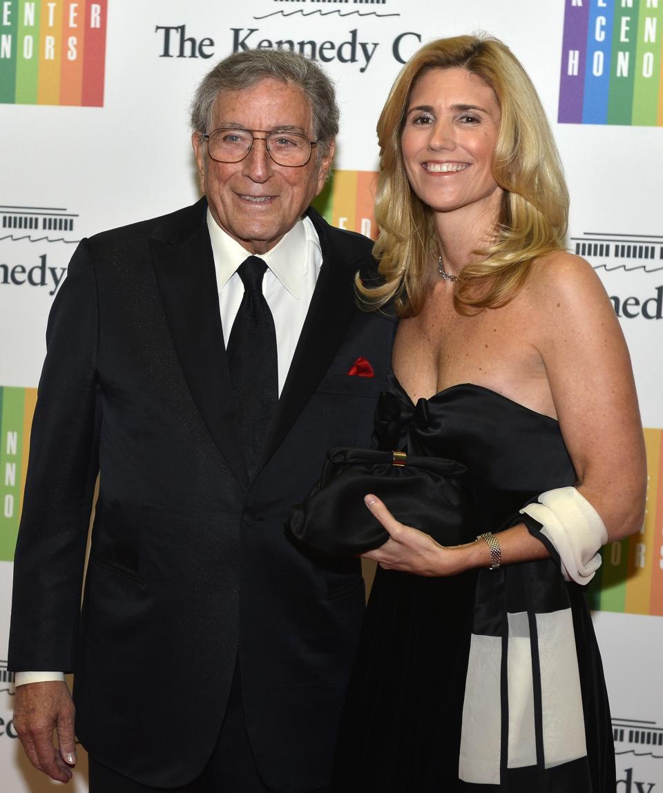 Singer Tony Bennett, 87, and his wife Susan Crow pose for photographers as they arrive at the U.S. State Department for a gala dinner to honor the 2013 Kennedy Center Honorees, in Washington