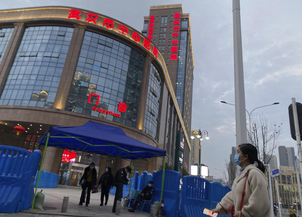 Security guards watch over the entrance of the Wuhan Central Hospital where Li Wenliang, the whistleblower doctor who sounded the alarm and was reprimanded by local police for it in the early days of Wuhan's pandemic, worked, in central China's Hubei province, Saturday, Feb. 6, 2021. Dr. Li Wenliang died in the early hours of Feb. 7 from the virus first detected in this Chinese city. A small stream of people marked the anniversary at the hospital. The 34-year-old became a beloved figure and a potent symbol in China after it was revealed that he was one the whistleblowers who authorities had punished early for “spreading rumors” about a SARS-like virus. (AP Photo/Ng Han Guan)