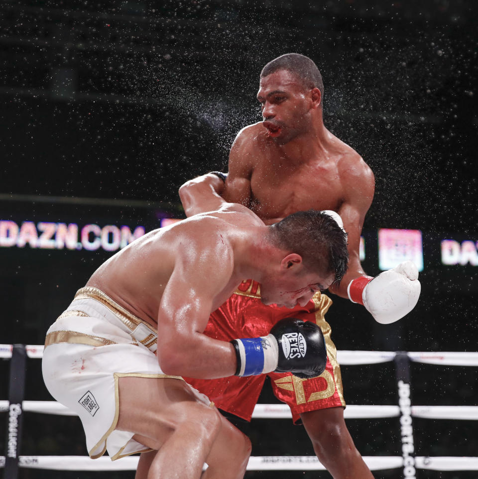 Thomas Dulorme, rear, hits Jessie Vargas during a boxing bout Saturday, Oct. 6, 2018, in Chicago. (AP Photo/Kamil Krzaczynski)