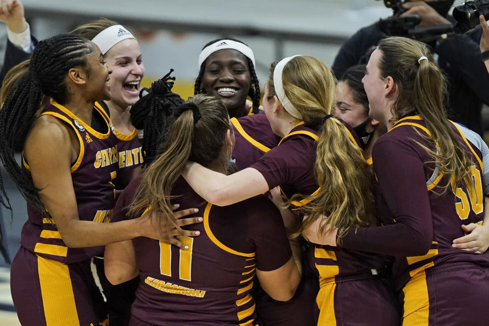 Central Michigan players celebrate after defeating Bowling Green 77-72 in an NCAA college basketball game in the championship of the Mid-American Conference tournament, Saturday, March 13, 2021, in Cleveland. (AP Photo/Tony Dejak)