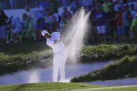 Tony Finau hits out of a fairway bunker on the first playoff hole against Webb Simpson during the final round of the Waste Management Phoenix Open PGA Tour golf event Sunday, Feb. 2, 2020, in Scottsdale, Ariz. (AP Photo/Ross D. Franklin)
