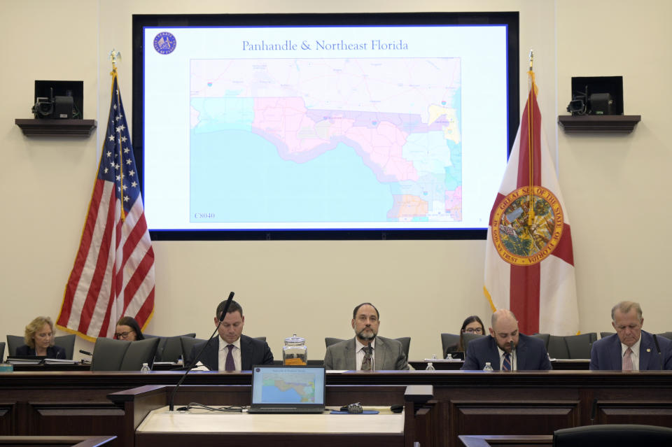 FILe - Florida Sen. Ray Rodrigues, center, views redistricting maps on a video monitor as an identical one is displayed behind him during a Senate Committee on Reapportionment hearing in a legislative session in Tallahassee, Fla. (AP Photo/Phelan M. Ebenhack, File)