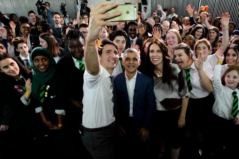 Ms Arden pictured with London mayor Sadiq Khan and Canadian Prime Minister Justin Trudeau (AP)