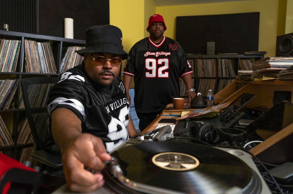 Slum Village members Young RJ, left, and T3 listen through a collection of records in search of samples to use for their next album at a home recording studio in Milford on Thursday, May 9, 2024.