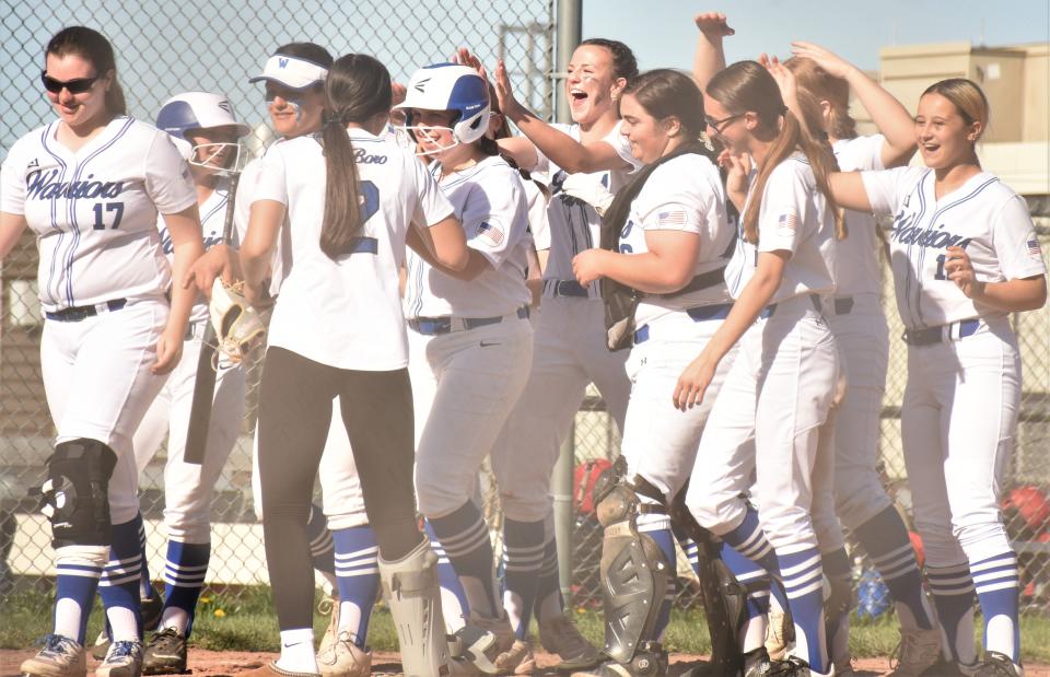 Teammates greet Whitesboro freshman Emma Zyskowski at home plate after her second inning home run against New Hartford Tuesday. Zyskowski had four hits and drove in four runs in a 12-7 victory that avenged Whitesboro's only loss in Tri-Valley League play.