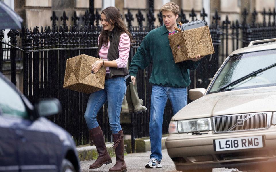 Ed McVey and Meg Bellamy filming the 'moving in scene' for The Crown - Splash News