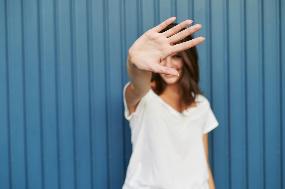 Portrait of woman covering her face with her hand