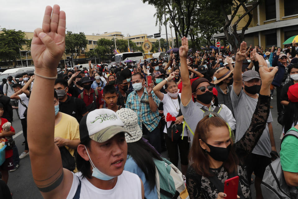 Anti-government protesters raise three-finger salutes, a symbol of resistance, during a protest near Democracy Monument in Bangkok, Thailand, Wednesday, Oct. 14, 2020. Thai activists hope to keep up the momentum in their campaign for democratic change with a third major rally in Bangkok on Wednesday. (AP Photo/Sakchai Lalit)