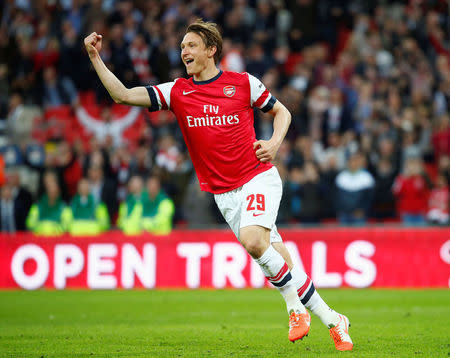 FILE PHOTO: Arsenal's Kim Kallstrom celebrates after scoring a penalty in their penalty shoot-out during their English FA Cup semi-final soccer match against Wigan Athletic at Wembley Stadium in London April 12, 2014. REUTERS/Eddie Keogh/File Photo