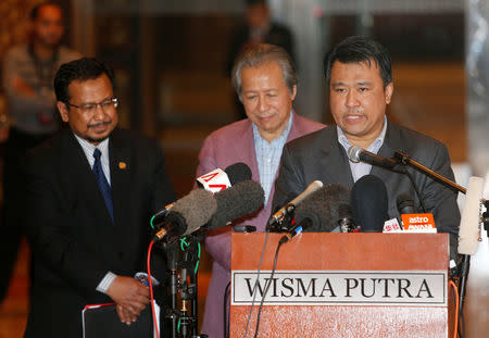 Mohd Nor Azrin Md Zain, counsellor at Malaysia's embassy in Pyongyang, addresses the media with Malaysia's Foreign Minister Anifah Aman (C) and Malaysia's ambassador to North Korea Mohamad Nizan Mohamad at the Kuala Lumpur International Airport in Sepang, Malaysia March 31, 2017. REUTERS/Lai Seng Sin