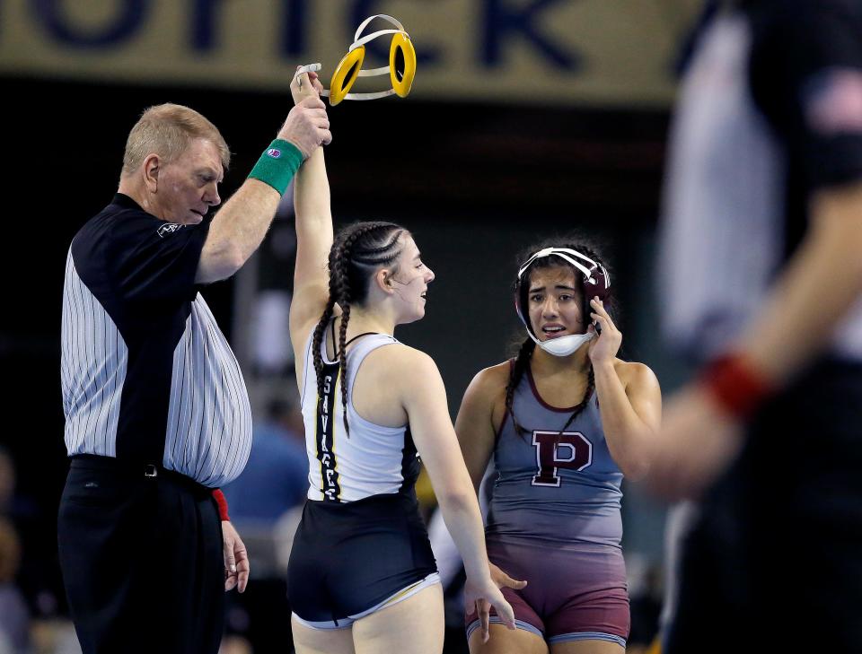 Tecumseh's Trinity Rakestraw celebrates the a win in the 5A girls 130-pound match over Perry's Alexi Valencia during a semifinal round of the Oklahoma high school state wrestling tournament in Oklahoma City, Friday, Feb. 23, 2024.