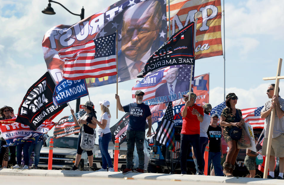 Supporters with T-shirts saying Ultra Maga wave flags saying such things as Let's Go Brandon and Trump 2024, America First.