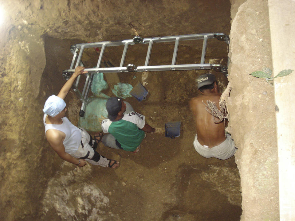 In this August 4, 2011 handout photo provided by Eusebio Dizon, Archeologists work inside Callao cave in Cagayan province, northern Philippines where they recovered fossil bones and teeth belonging to a new human species they called Homo Luzonensis. Archaeologists who discovered fossil bones and teeth of a previously unknown human species that thrived more than 50,000 years ago in the northern Philippines say they plan more diggings and better protection of the popular limestone cave complex where the remains were unearthed. (Eusebio Dizon via AP)