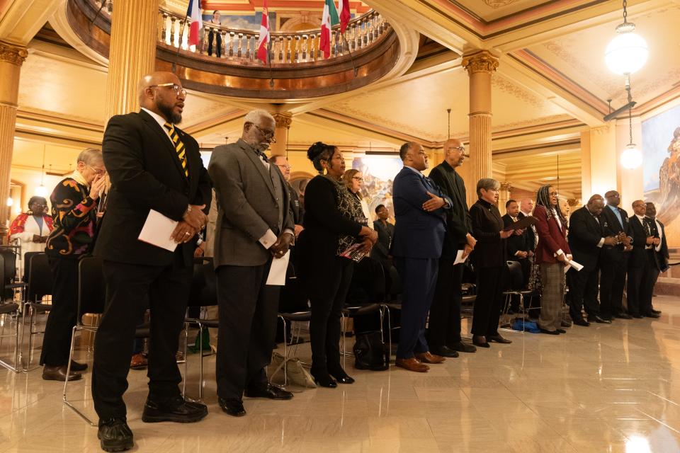 Participants at Thursday's program to honor the Rev. Martin Luther King Jr. sing the Black National Anthem at the Kansas Statehouse.