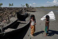 Children collect wood from remnants of some 20 boats that ferried Rohingya refugees fleeing violence in Myanmar, which were destroyed by Bangladeshi authorities the night before, at Shah Porir Dwip near Cox's Bazar, Bangladesh October 4, 2017. REUTERS/Damir Sagolj