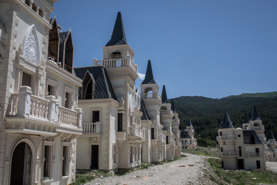 With ornate Gothic-inspired architectural details, including flying buttresses, pointed arches, and ribbed vaulting, the nearly identical castles line the winding roads just outside the Roman spa town of Mudurnu. Hardly any of the gardens made it to the landscaping phase of the project, giving the neighborhood a cold postwar feel.