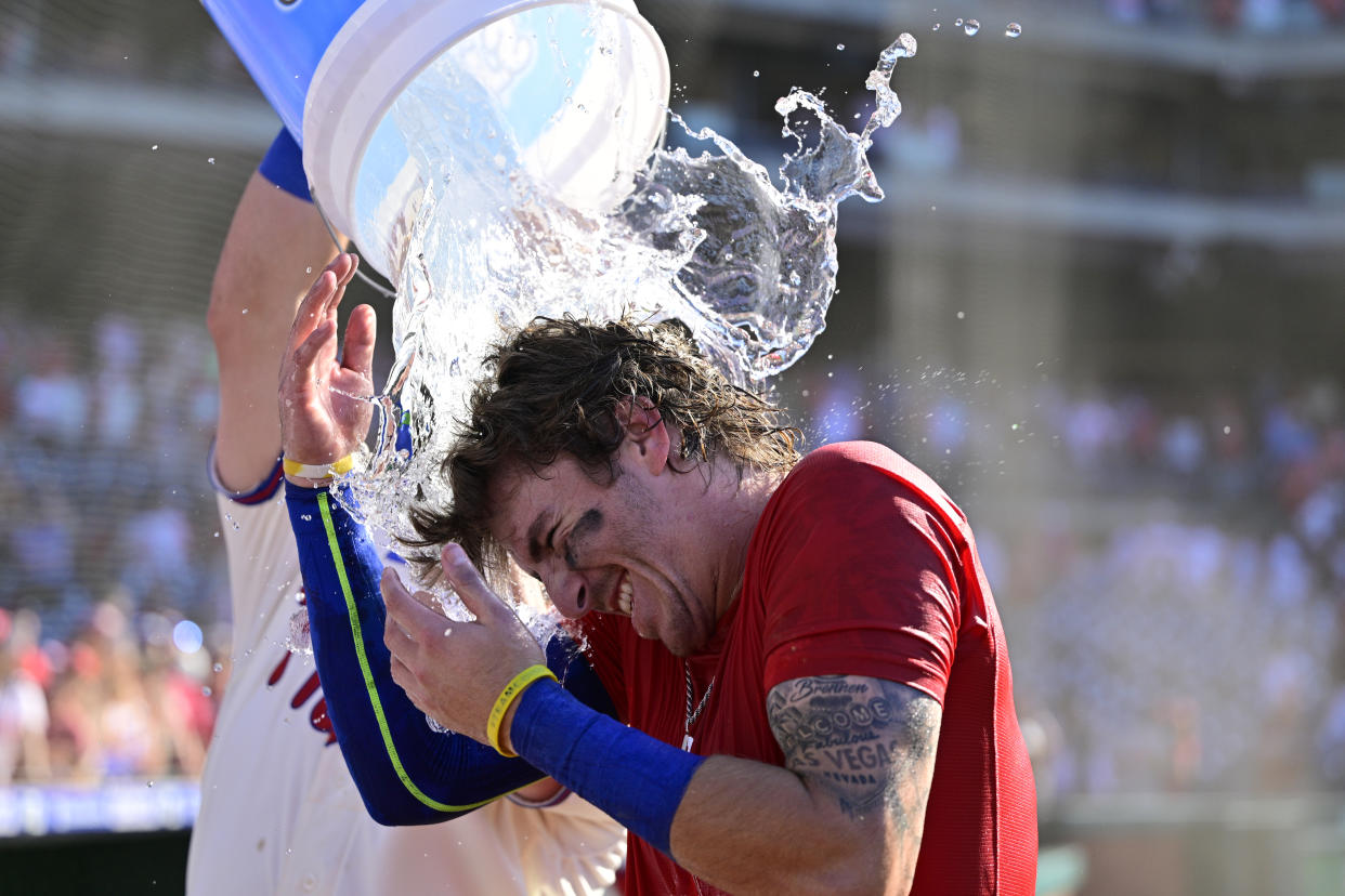 Philadelphia Phillies' Bryson Stott is doused by teammates after hitting a walkoff three-run home run during the ninth inning of a baseball game off Los Angeles Angels' Jimmy Herget, Sunday, June 5, 2022, in Philadelphia. (AP Photo/Derik Hamilton)