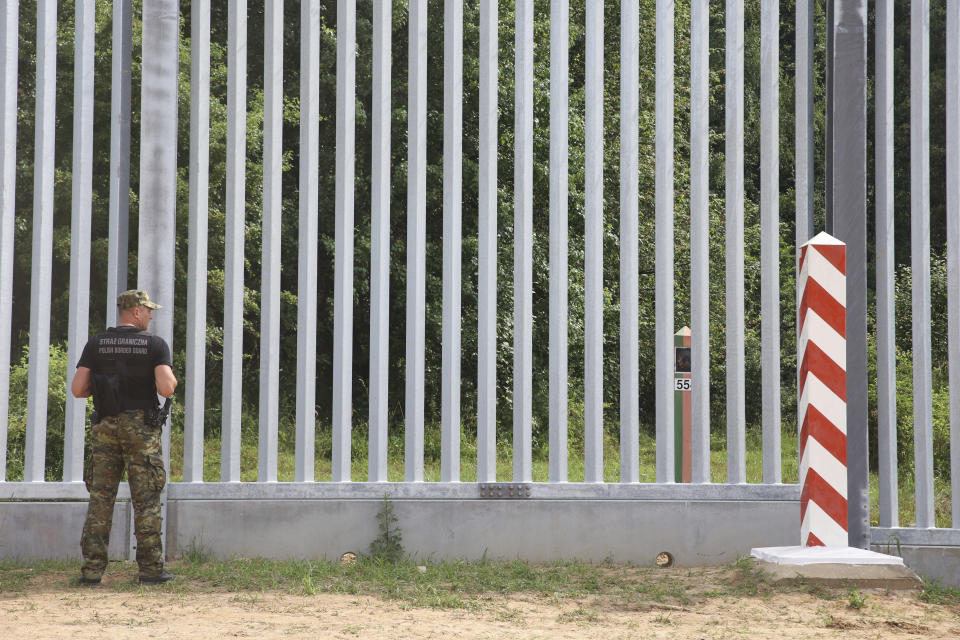 FILE - A Polish border guard patrols the area of a newly built metal wall on the border between Poland and Belarus, near Kuznice, Poland, Thursday, June 30, 2022. Polish officials said on Thursday, Aug. 4, 2022, that most of those seeking to enter Poland illegally now are Africans who first traveled to Russia, instead of people from the Mideast. (AP Photo/Michal Dyjuk, File)