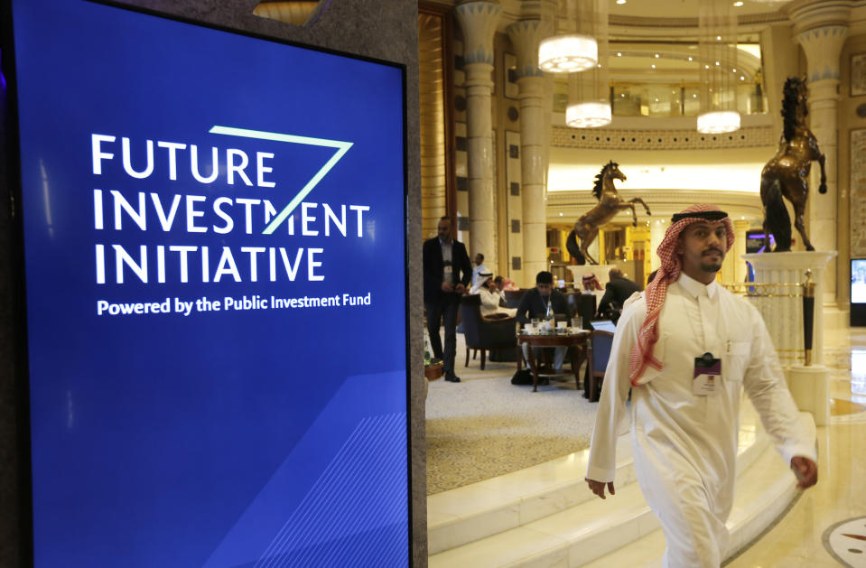 A participant at the Future Investment Initiative walks in the Ritz Carlton Hotel a day before the event, in Riyadh, Saudi Arabia, Monday, Oct. 28, 2019. The initiative is an annual investment forum held in Riyadh, to discuss trends in the world economy and investment environment hosted by the Public Investment Fund of Saudi Arabia. (AP Photo/Amr Nabil)