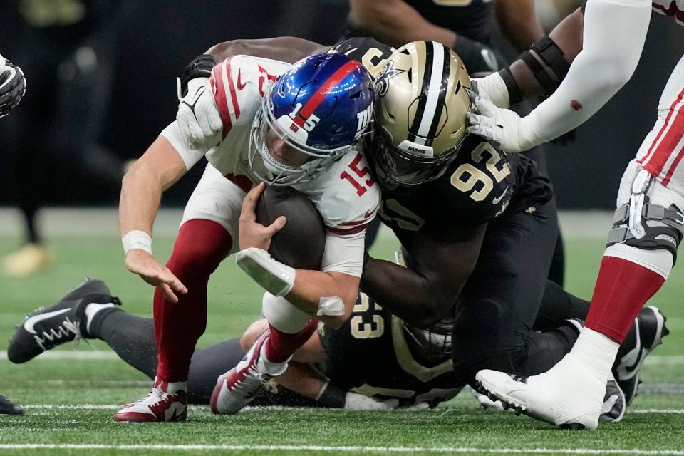 New York Giants quarterback Tommy DeVito (15) is sacked by New Orleans Saints defensive end Tanoh Kpassagnon (92) during the second half of an NFL football game Sunday, Dec. 17, 2023, in New Orleans. (AP Photo/Gerald Herbert)