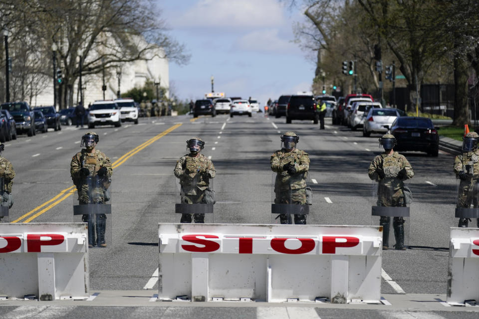 National Guard troops stand guard after a car that crashed into a barrier on Capitol Hill in Washington, Friday, April 2, 2021. (AP Photo/Carolyn Kaster)