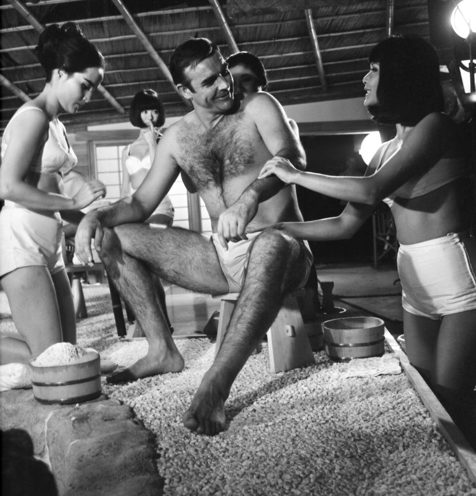 FILE - In this file photo dated Sept. 26, 1966, British actor Sean Connery, being given a Japanese bath, during filming of a scene in the James Bond film, You Only Live Twice, at Pinewood Studios near London. The actresses shown are Yasuko Nagazuni, at left and Yee Wah Yang at right. Scottish actor Sean Connery, considered by many to have been the best James Bond, has died aged 90, according to an announcement from his family. (AP Photo/Sidney Smart, FILE)