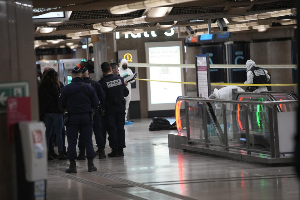 Police investigators work inside the Gare de Lyon station after an attack, Saturday, Feb. 3, 2024 in Paris. A man seemingly armed with a knife and a hammer injured three people Saturday in an early-morning attack at the major Gare de Lyon train station in Paris, another nerve-rattling security incident in the Olympic host city before the Summer Games open in six months. (AP Photo/Christophe Ena)