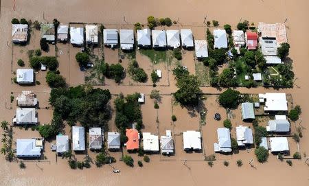 Houses are surrounded by floodwaters brought on by Cyclone Debbie at Depot Hill in Rockhampton, Australia, April 6, 2017. AAP/Dan Peled/via REUTERS