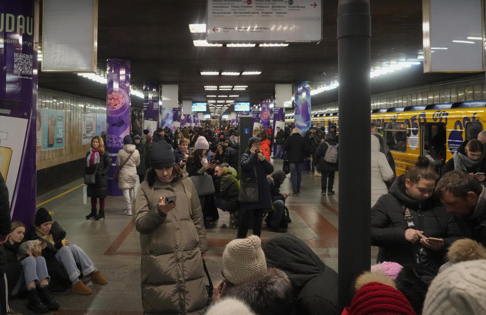 People rest in the subway station, being used as a bomb shelter during a rocket attack in Kyiv, Ukraine, Friday, Dec. 16, 2022. Ukrainian authorities reported explosions in at least three cities Friday, saying Russia has launched a major missile attack on energy facilities and infrastructure. Kyiv Mayor Vitali Klitschko reported explosions in at least four districts, urging residents to go to shelters. (AP Photo/Efrem Lukatsky)