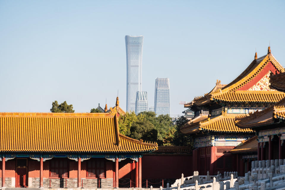 The forbidden city in Beijing and modern buildings in the background.
