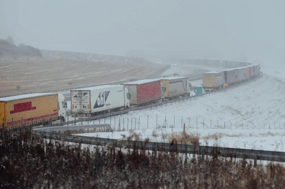 Snow-covered trucks stand in a long, over 7 kilometers long queue near Bidovce, Slovakia on November 28, 2023. (Robert Nemeti/Anadolu via Getty Images)